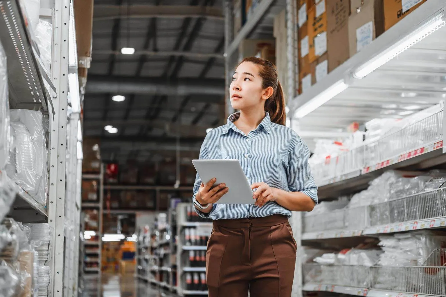 Warehouse manager checking inventory on a tablet